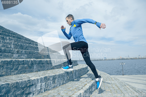 Image of Man running on city background at morning.