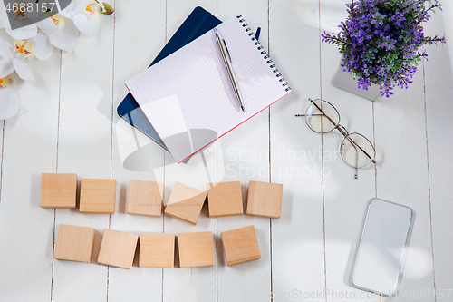 Image of Message at wooden cubes on a desk background.