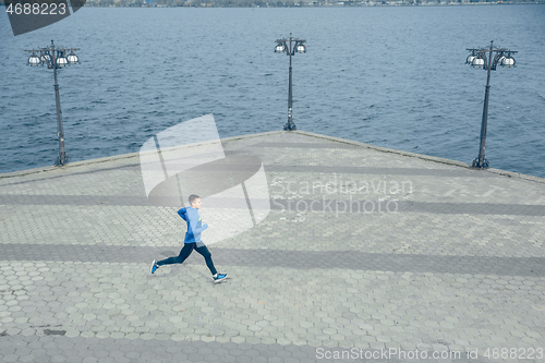 Image of Man running on city background at morning.