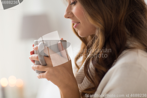 Image of close up of happy woman with cup of coffee at home