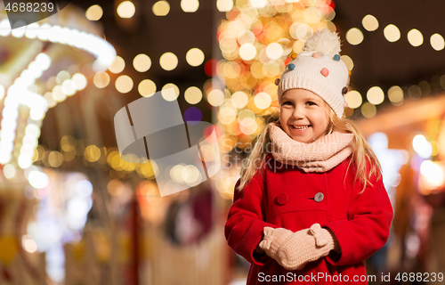 Image of happy little girl at christmas market in winter