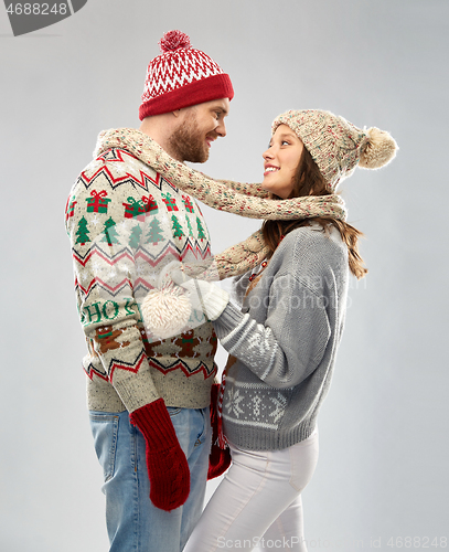 Image of happy couple at christmas ugly sweater party