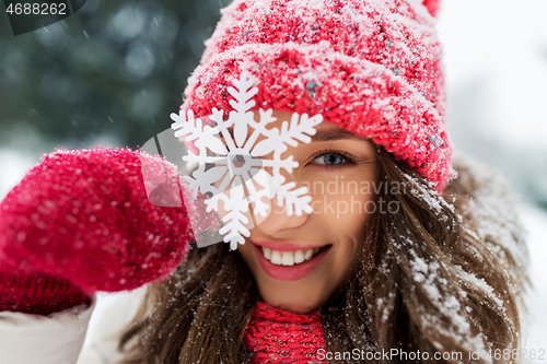 Image of portrait of teenage girl with snowflake in winter