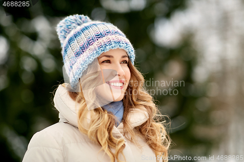 Image of portrait of happy smiling woman outdoors in winter