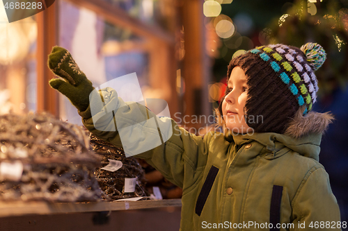 Image of happy little boy at christmas market in winter