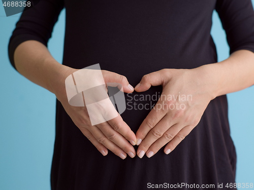 Image of Portrait of pregnant woman over blue background