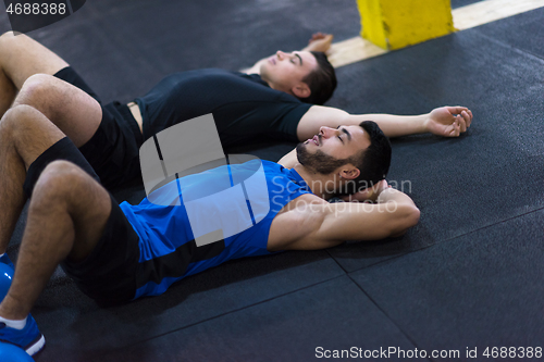 Image of young athletes lying on the floor and relaxing