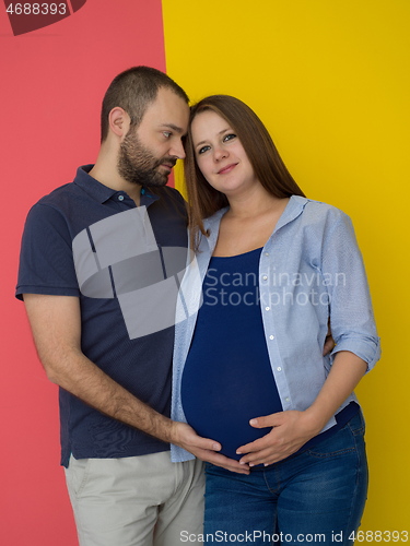 Image of pregnant couple  isolated over colorful background