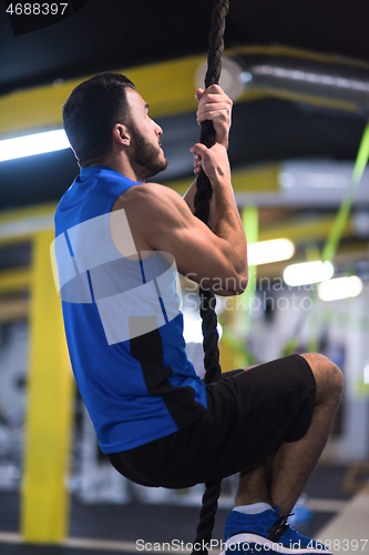 Image of man doing rope climbing