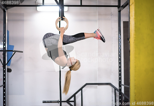 Image of woman working out on gymnastic rings