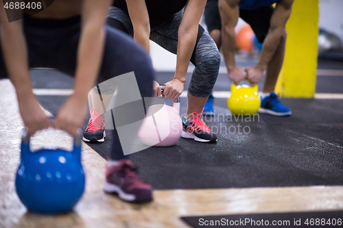 Image of athletes doing exercises with kettlebells