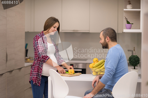 Image of couple cooking food fruit lemon juice at kitchen