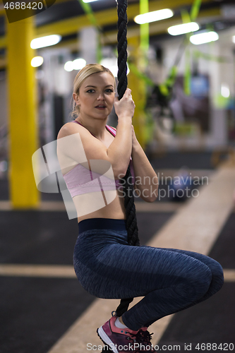 Image of woman doing rope climbing