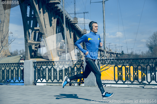 Image of Man running on city background at morning.