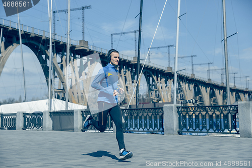 Image of Man running on city background at morning.