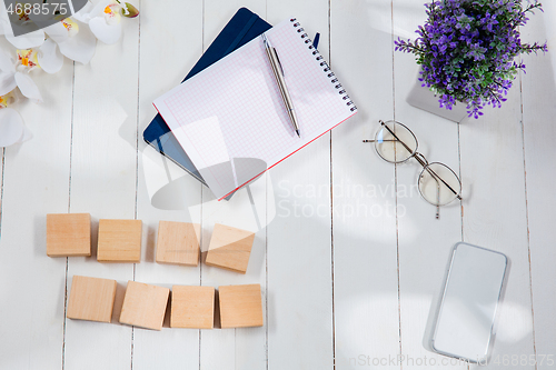 Image of Message at wooden cubes on a desk background.