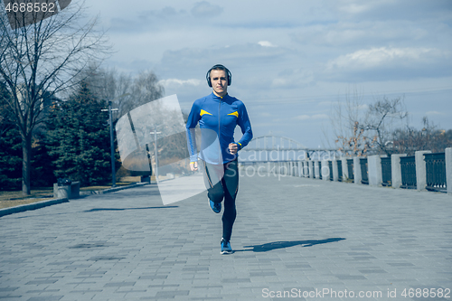 Image of Man running on city background at morning.