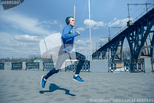 Image of Man running on city background at morning.