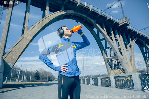 Image of Man running on city background at morning. Healthy lifestyle concept.