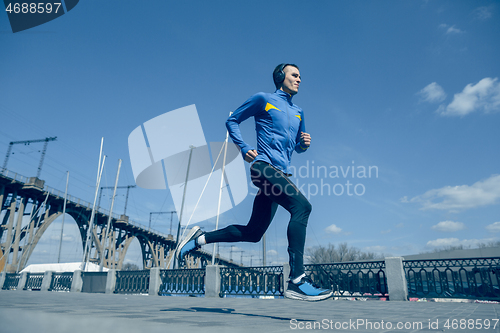 Image of Man running on city background at morning.