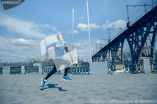 Image of Man running on city background at morning.