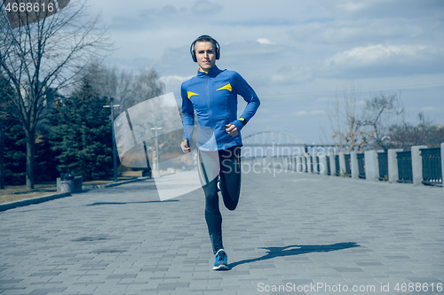 Image of Man running on city background at morning.