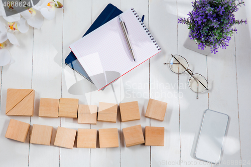 Image of Message at wooden cubes on a desk background.