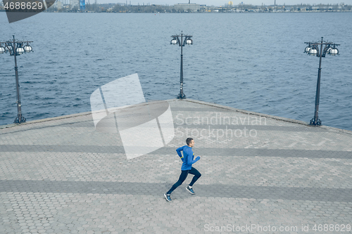 Image of Man running on city background at morning.