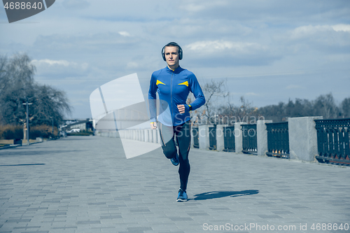 Image of Man running on city background at morning.