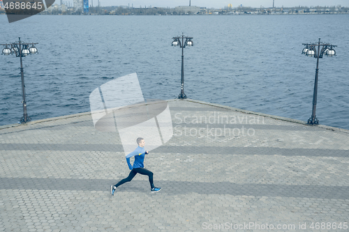 Image of Man running on city background at morning.