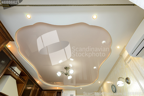 Image of Original stylish multi-level stretch ceiling in the interior of a rich kitchen