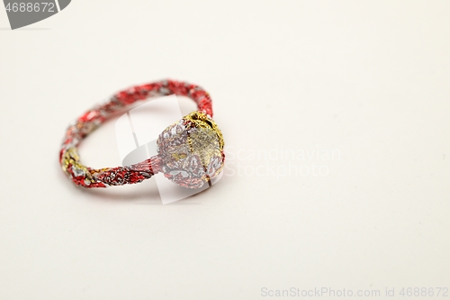 Image of unpretentious ring made from recycled materials on a white backg