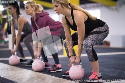 Image of athletes doing exercises with kettlebells