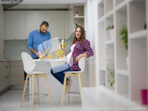 Image of couple cooking food fruit lemon juice at kitchen