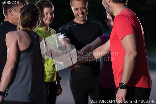 Image of runners giving high five to each other