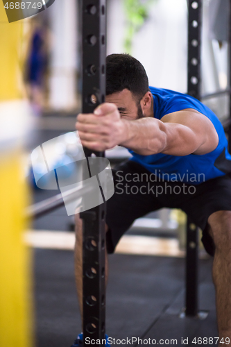 Image of man doing pull ups on the vertical bar