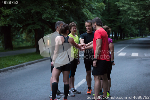 Image of runners giving high five to each other