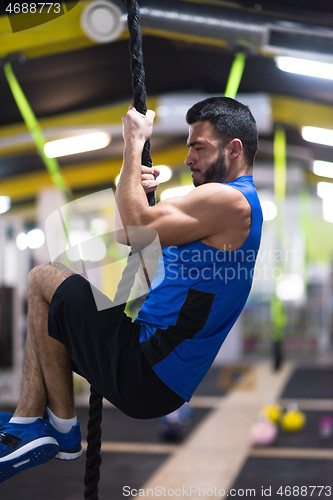 Image of man doing rope climbing