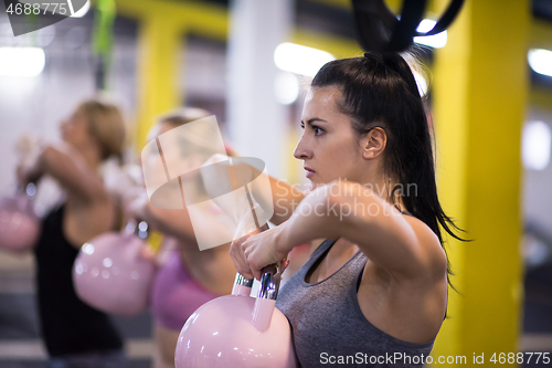 Image of athletes doing exercises with kettlebells