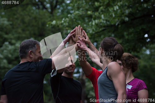 Image of runners giving high five to each other