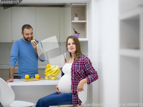 Image of couple cooking food fruit lemon juice at kitchen