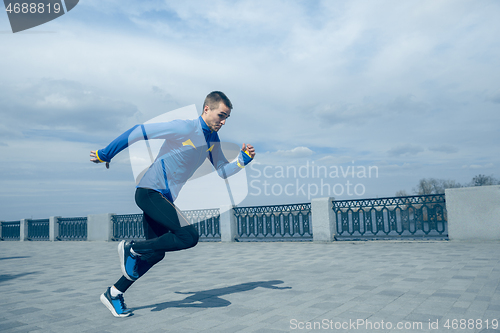 Image of Man running on city background at morning.