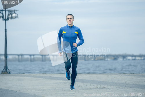 Image of Man running on city background at morning.