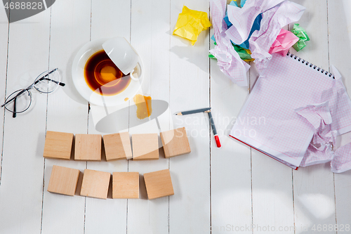 Image of Message in wooden cubes on a desk background.