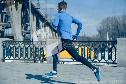 Image of Man running on city background at morning.