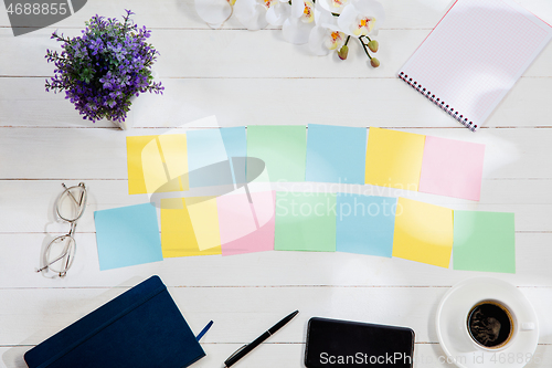 Image of Message at colorful note papers on a desk background.