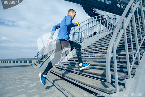 Image of Man running on city background at morning.