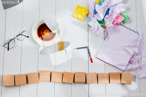 Image of Message in wooden cubes on a desk background.