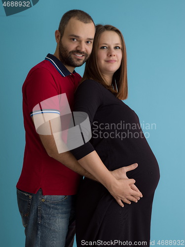 Image of pregnant couple  isolated over blue background