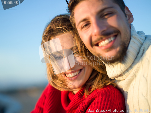 Image of couple on a beach at autumn sunny day